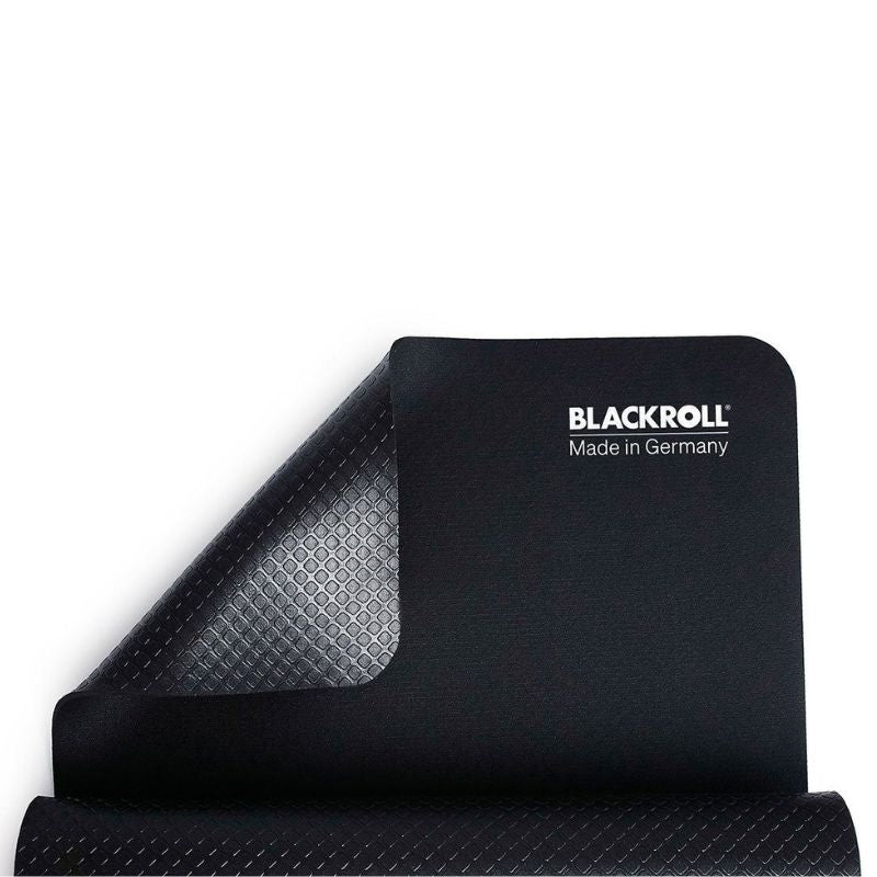 BLACKROLL Mat In Black Colour Top Part View With Non Slip Part Showing and Half Rolled