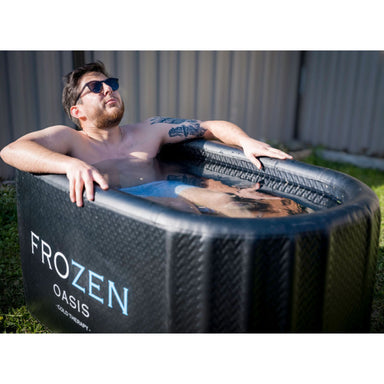 Male enjoying Frozen Oasis black cold plunge outdoors
