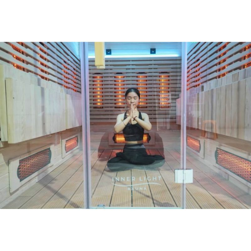 Innerlight 8 Person Seated Full Spectrum Infrared Hot Yoga Sauna with female inside doing yoga