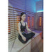 Innerlight 8 Person Seated Full Spectrum Infrared Hot Yoga Sauna with female doing yoga pose while seating in sauna seat