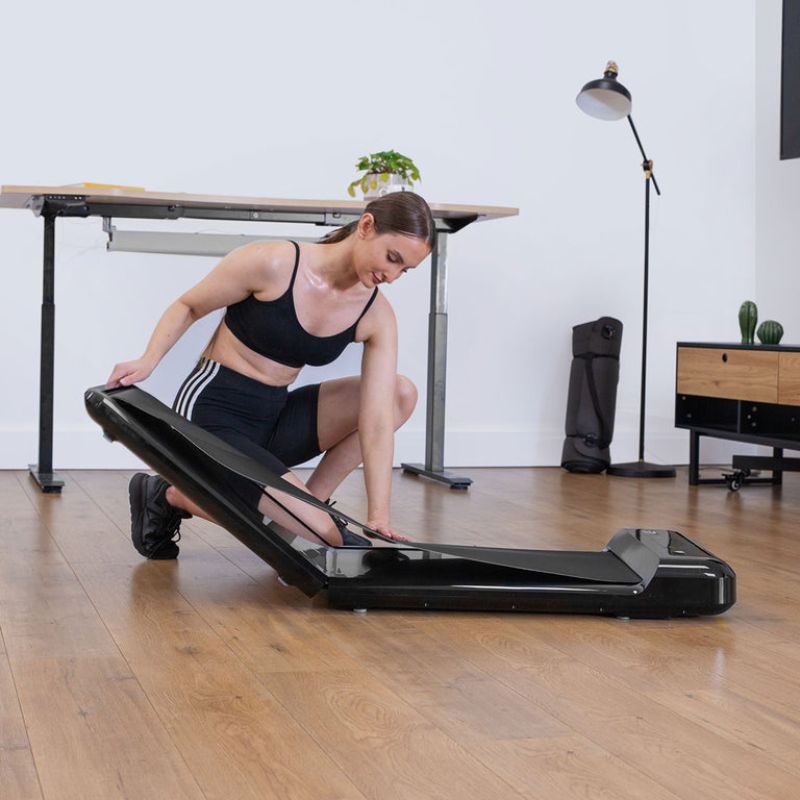 Lifespan Fitness WalkingPad™ M2 Treadmill with woman folding it after using