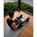 NERV Squeeze Heated Compression Boots with man using it while  using his phone